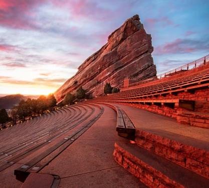 The Red Rocks Park Amphitheatre in Denver, Colorado at sunset.