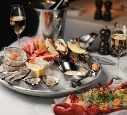 A spread of assorted seafood with champagne at Water Grill Denver in Denver, Colorado.