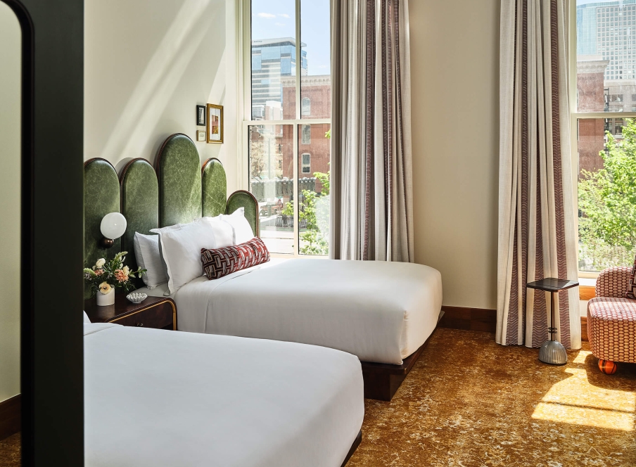 Two queen beds in the Deluxe Classic Guest Room at the Crawford Hotel in Denver, Colorado.