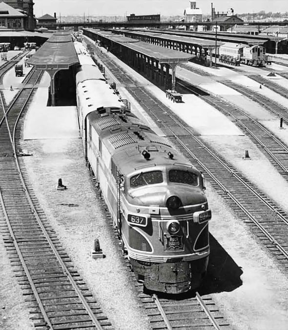 A historical picture of a train leaving a train station in Denver, Colorado.