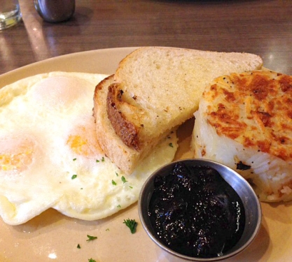 A breakfast of 3 over-easy eggs, toast, blueberry jam and a hashbrown from Snooze at the Denver Union Station in Denver, Colorado.