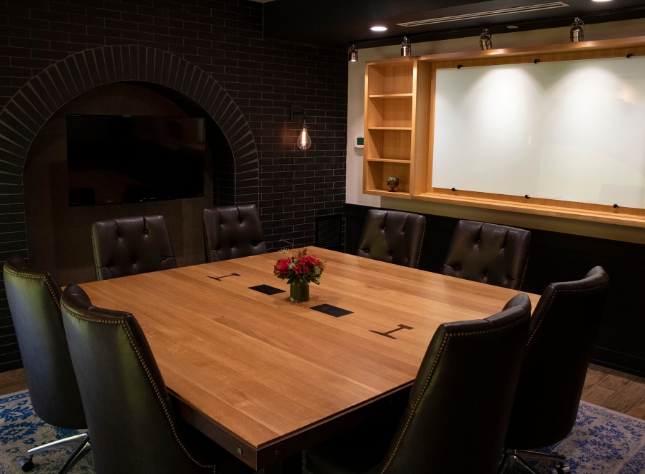 A boardroom table and shelving in the Larimer Boardroom at the Crawford Hotel in Denver, Colorado.