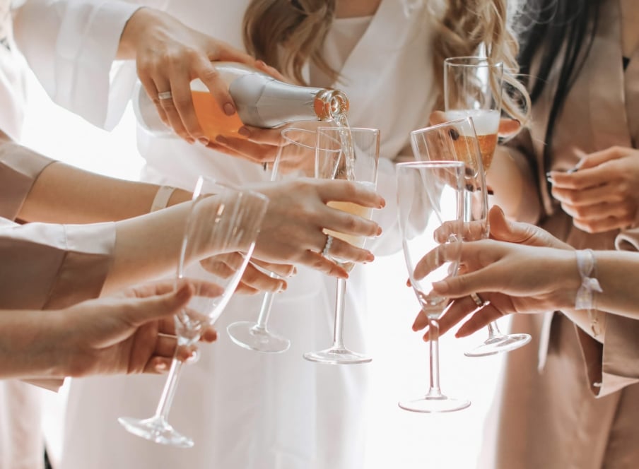 A bridal party pouring rose.
