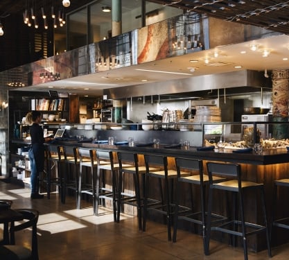 Bar seating and open kitchen at Stoic and Genuine restaurant in Denver, Colorado.