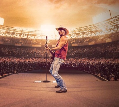 Kenny Chesney plays guitar in a full stadium.