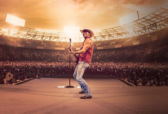 Kenny Chesney plays guitar in a full stadium.