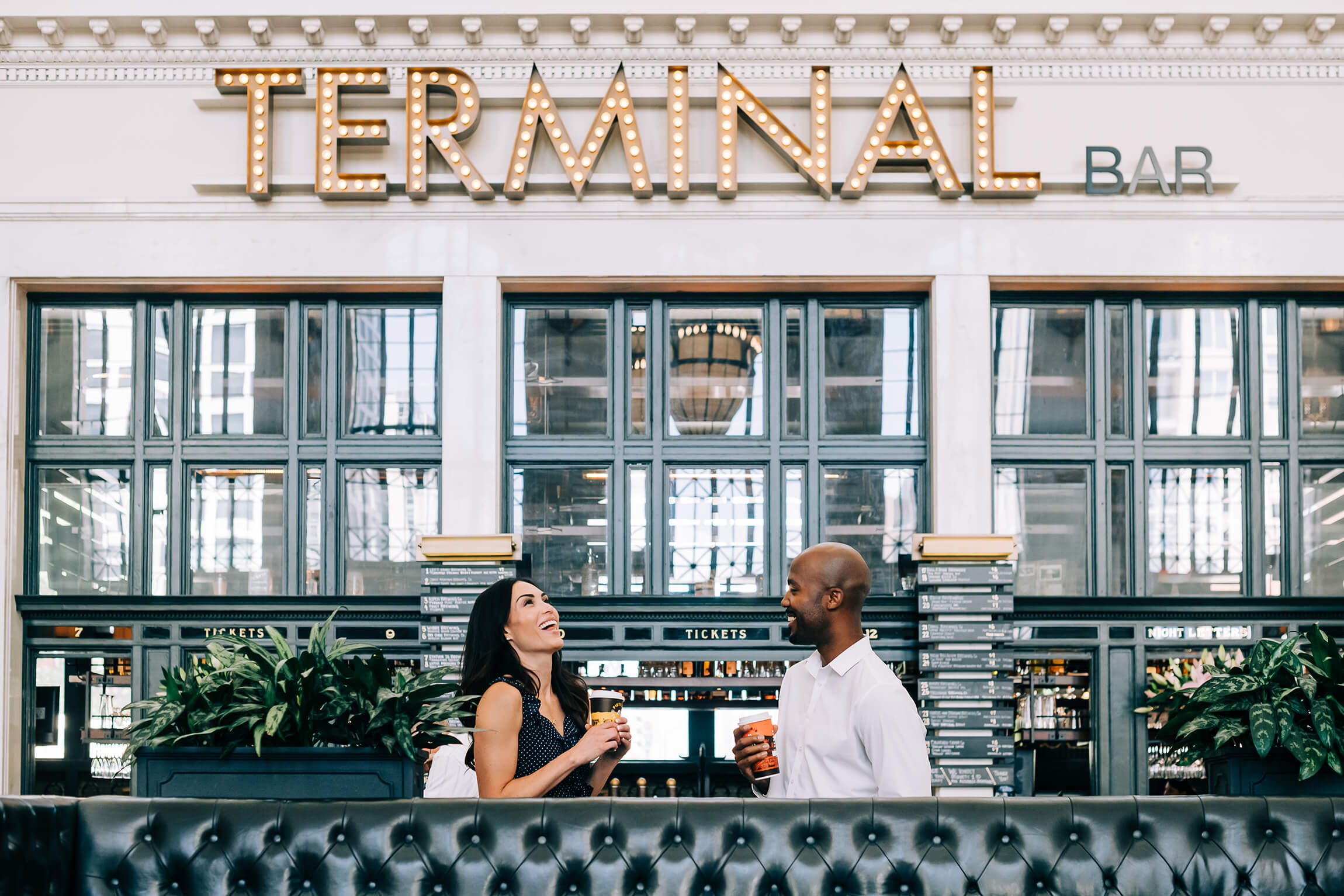 Two people laugh over coffee at the Terminal Bar.