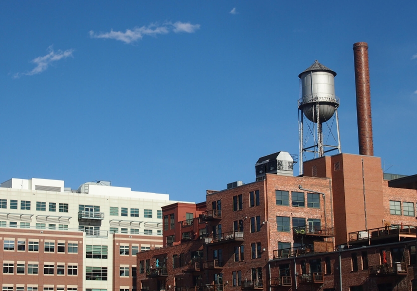 An industrial looking brick building on a clear, sunny day.